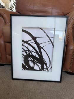 Black and white print, black framed glass.