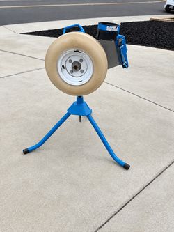 Jugs jr pitching machine, and two buckets of dimple balls