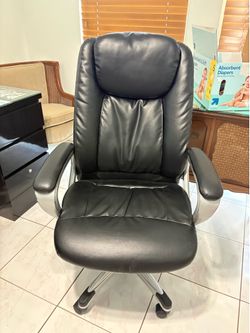 Black leather at office chair on wheels