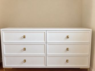 White dresser with gold hardware