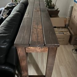 Long wooden table with barstools 
