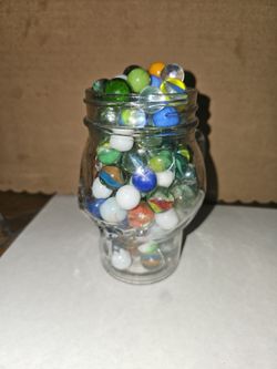 Jar of mixed vintage and new marbles