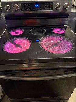 Samsung bottom freezer/fridge and  dark  gray color stainless  stove.