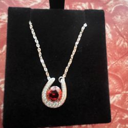 Stirling silver horseshoe necklace with a January Garnet stone