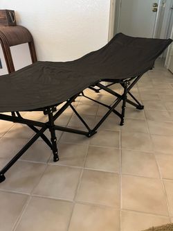Folding cot with mattresses
