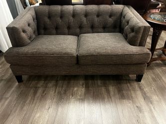 Charcoal grey tufted loveseat