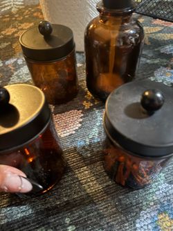 Three glass smoked jars, lidless soap dispenser