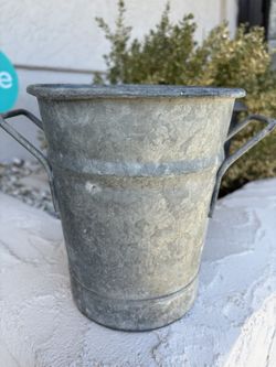 metal tub with handles is a rustic tabletop planter or farmhouse decor container