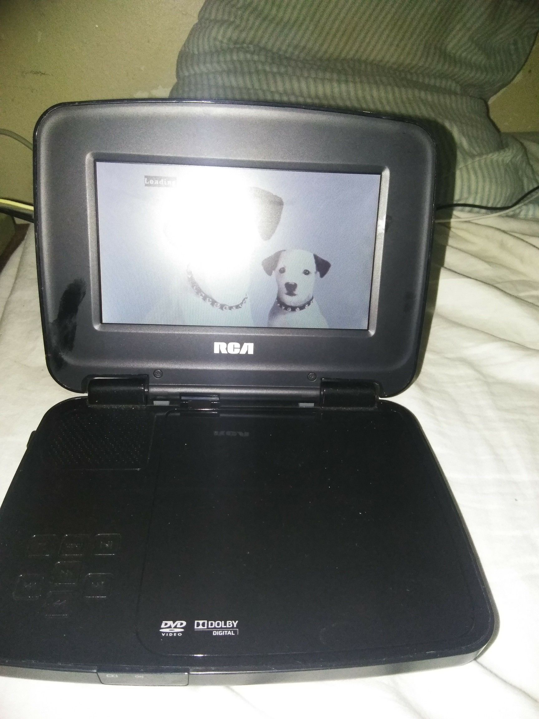 RCA Portable DVD player with wall charger included.