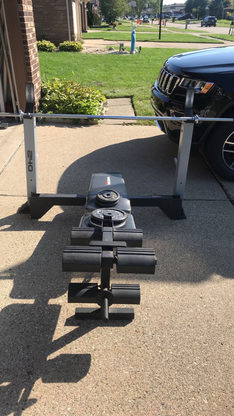 Bench press machine, bar, and weights