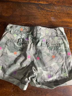 Justice Girls camo shorts with peace signs in pink, orange, and purple. Size 8Small