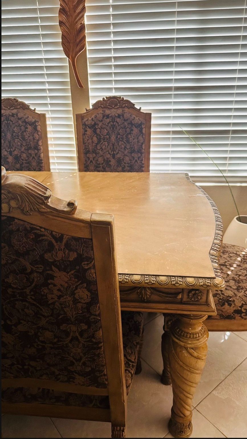 Cozy dining room set with a charming wooden table and matching chairs.