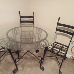 Dinning table with four chairs. Glass is heavy.