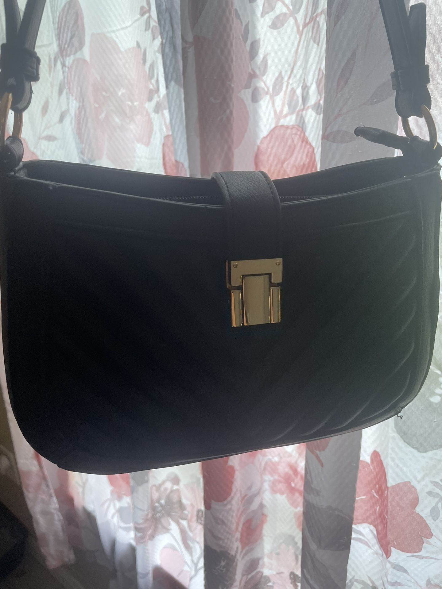 Black Handbag With Gold Accents And Leopard Print Inside