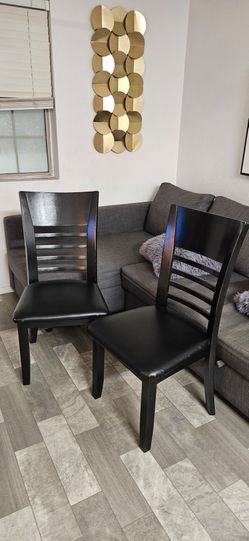 2 black dining chairs