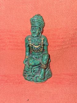 A green man statue , three inches by seven inches