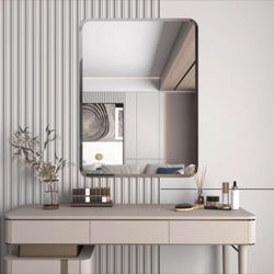 Rounded rectangular frameless beveled bathroom mirror