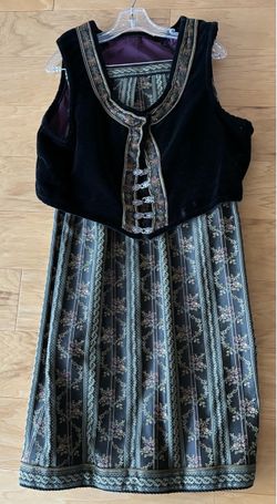 Black velvet vest with fancy pewter clasps. Trim on vest matches skirt. Skirt is open in back and needs closing clasps.