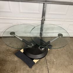 BEAUTIFUL ADJUSTABLE GLASS TABLE IN EXCELLENT CONDITION. $60.00 OR BEST OFFER 