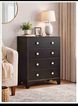 Brand new. Still in box.. Stylish black 4-drawer dresser. Has cool gold trim and white/gold round knobs. Drawers open smoothly. Great for bedroom, hal