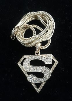 Goldtone or silvertone pendant Superman pendant. I will include a free chain with each pendant purchased. Brand new! Only $30.