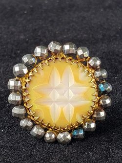 $10. Unusual ring mother of pearl silvertone and gold toned ring. Size 8. One inch in diameter.