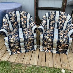 Two low floral armchairs