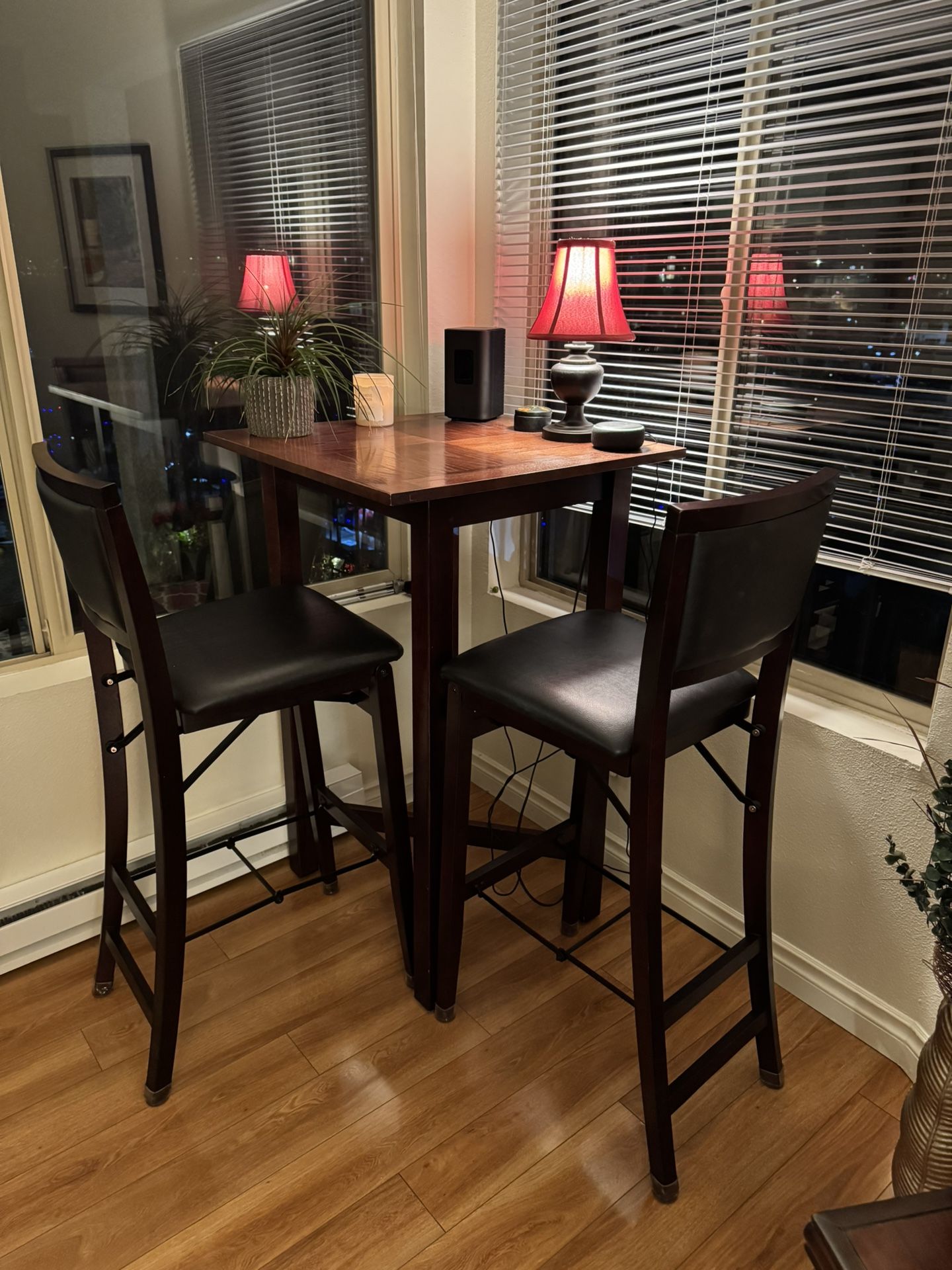 Bistro table that includes four padded chairs