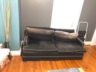 Down sofa. Dyed from sun at top cushions.