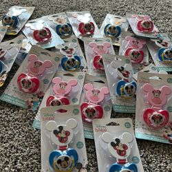Binkies. Mickey and Minnie with clips attached.