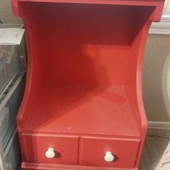 Red night stand with 1 drawer.