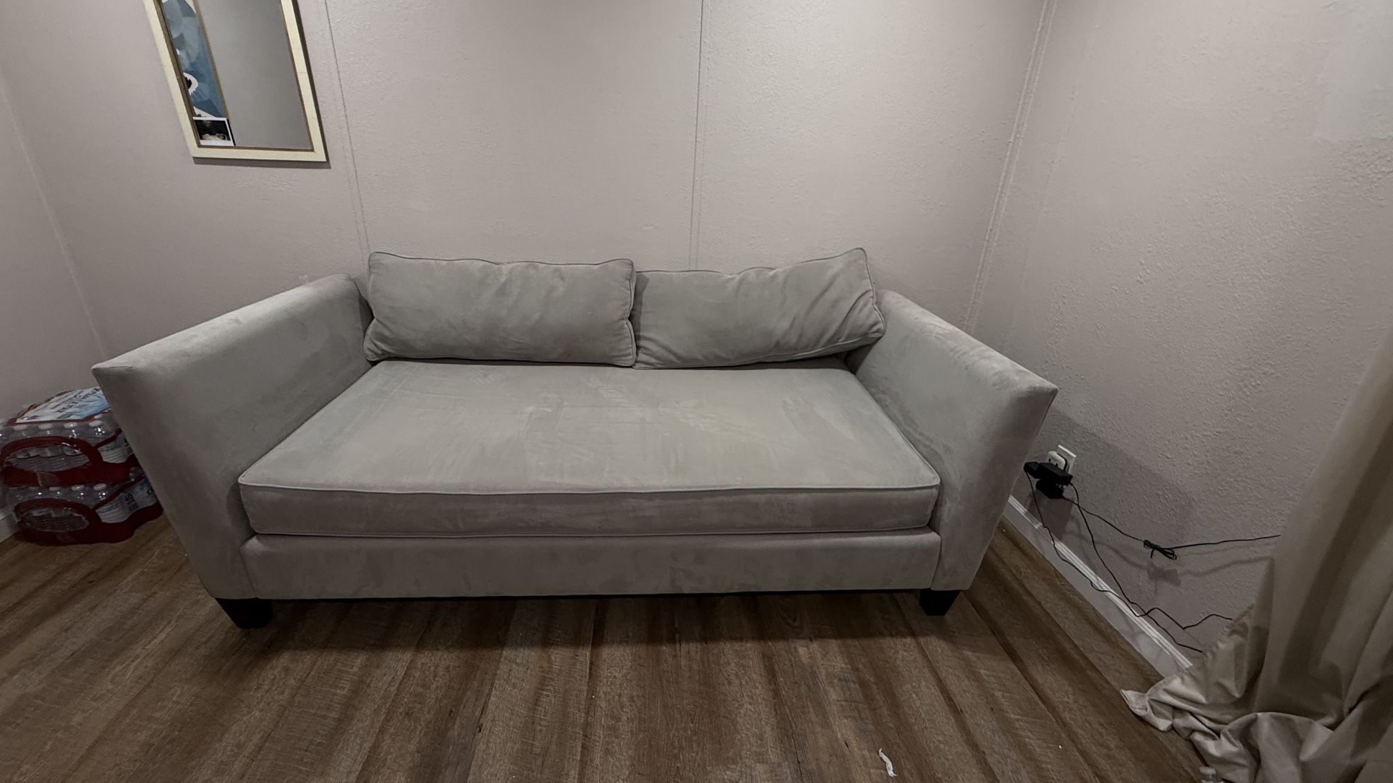 Living Spaces Grey Couch With Two Pillows