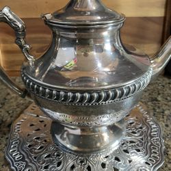 Silver covered copper tea pot