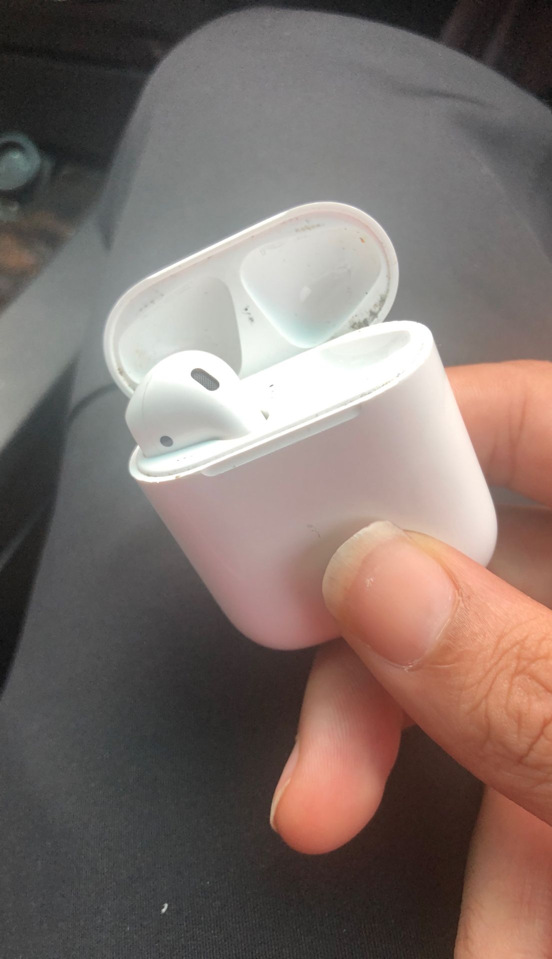 Left AirPod and Charging Case
