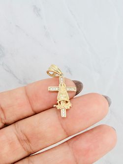 10K Gold Virgin of Charity Pendant Cross 	•	Authentic 10K yellow gold pendant 	•	Accented with white cubic zirconia stones 	•	Virgin of Charity measur