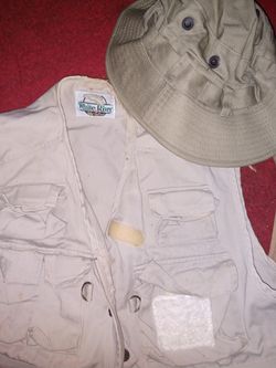 Bass pro fishing vests (2) hat(1) waders(1) assorted tackle and a puma jacket