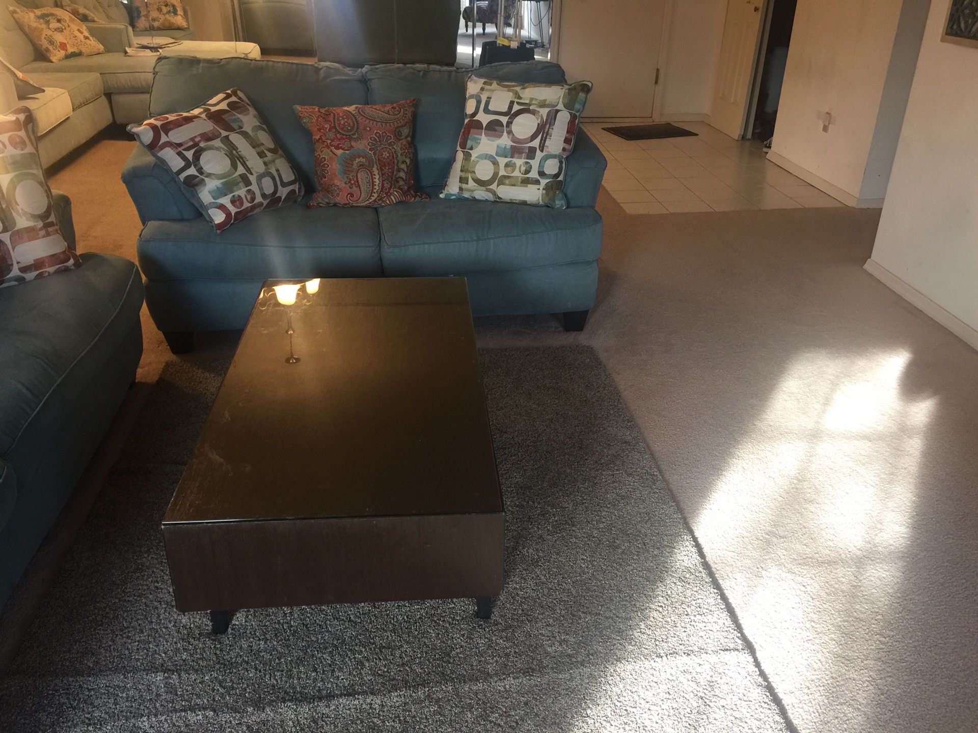 Two sofa, a coffee table, and blue rug.