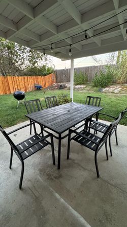 Black patio table and 6 chairs