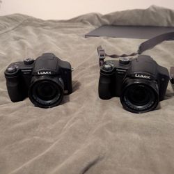 Lumix Cameras With Battery Packs And Two SD Cards With Adapter S