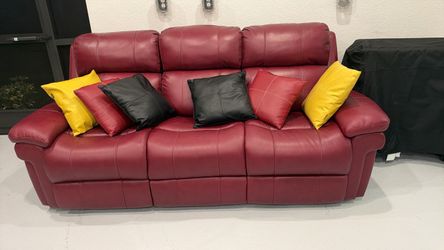 Burgundy leather sofa and pillows