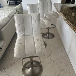 Set of 3 white swivel bar stools.