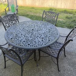 Cast Iron Table and 4 Chairs. 