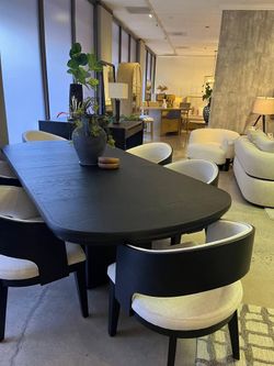 Large Dining set features Burnished black finish & Barrel-back arm chairs