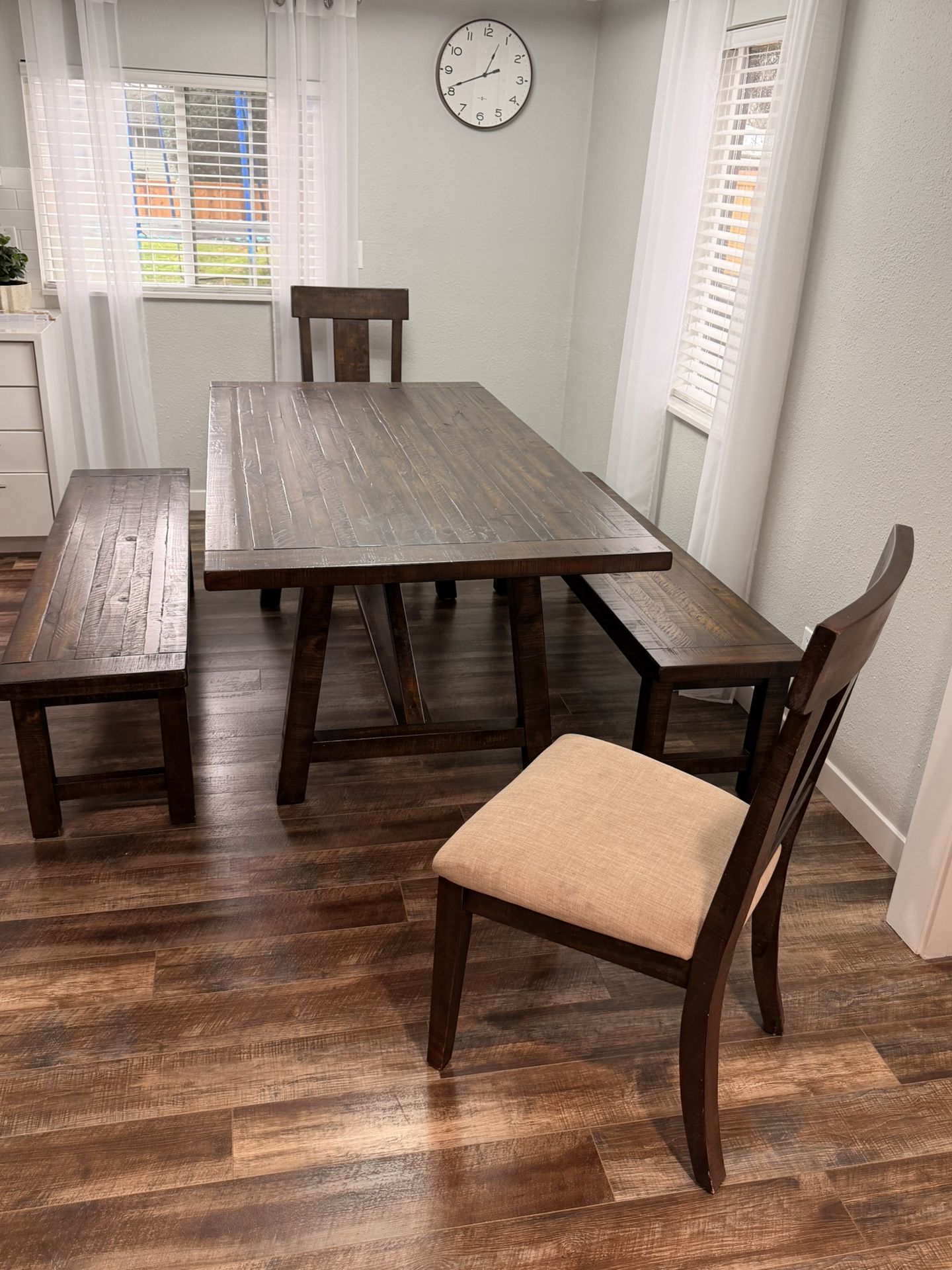 dining table with benches and two cushions chairs