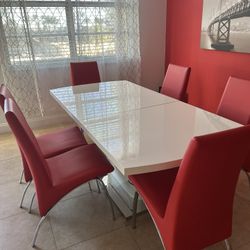 White table with 6 red chairs