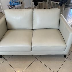 Abbyson Loveseat And A White Couch Both Leather