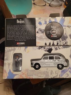 Beatles corgi newspaper taxi and figure