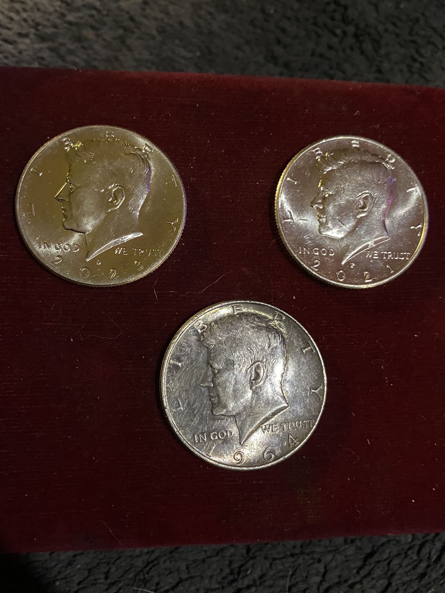 Three Kennedy half dollars that came out of a $10 roll