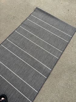 Indoor outdoor gray rug with white stripe