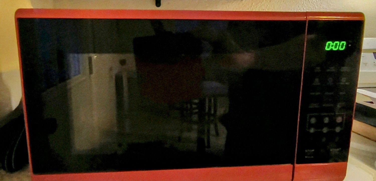 LIKE NEW BLACK AND RED MINI MICROWAVE.